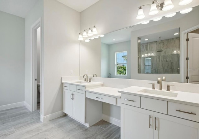 bathroom featuring vanity, toilet, and a tile shower