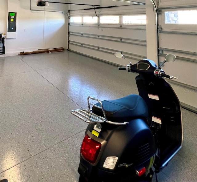 garage featuring electric panel and a garage door opener