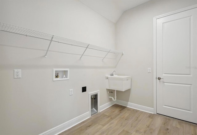 clothes washing area with hookup for a washing machine, laundry area, baseboards, light wood-type flooring, and electric dryer hookup