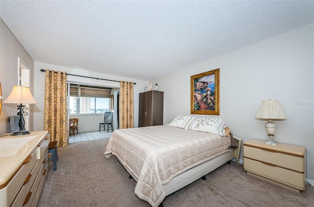 carpeted bedroom with a textured ceiling