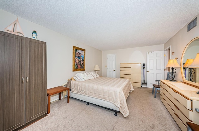 carpeted bedroom with a textured ceiling