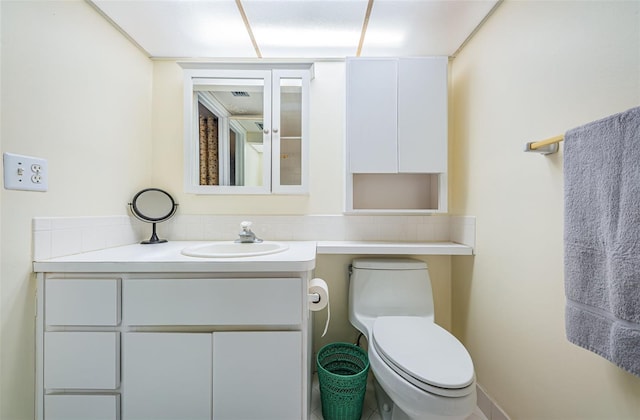 bathroom featuring vanity and toilet