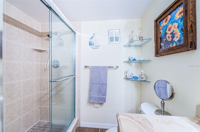 bathroom featuring vanity, toilet, and walk in shower