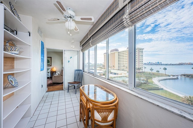 interior space featuring ceiling fan and a water view