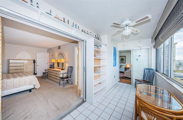 bedroom featuring ceiling fan and light colored carpet