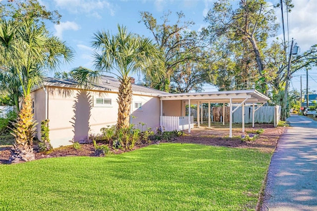 single story home featuring a carport and a front yard