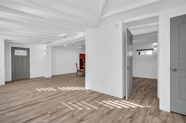 interior space with beamed ceiling and light hardwood / wood-style floors