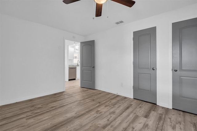 unfurnished bedroom with ceiling fan and light hardwood / wood-style floors