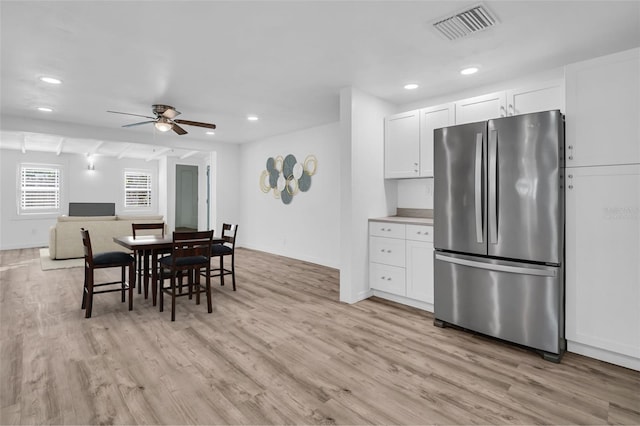 dining room featuring ceiling fan and light hardwood / wood-style flooring