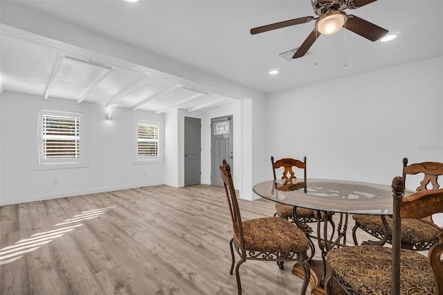 dining space with vaulted ceiling with beams, ceiling fan, and light hardwood / wood-style flooring