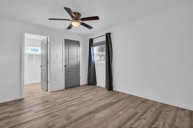 unfurnished bedroom with ceiling fan and light wood-type flooring