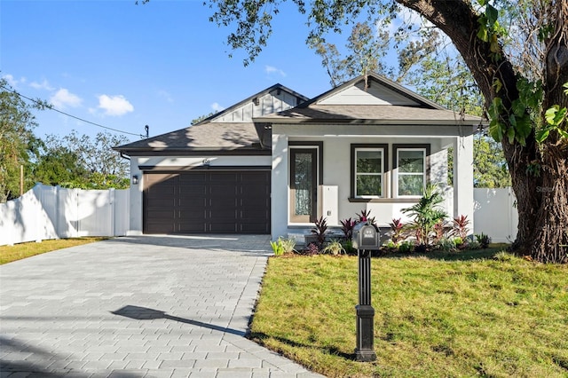 view of front of home with a front lawn and a garage