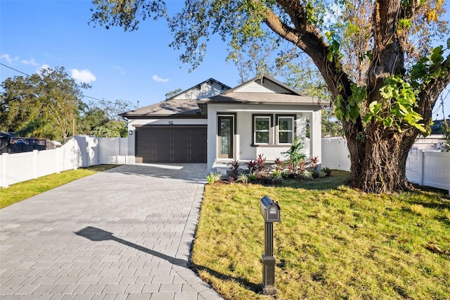 view of front of property featuring a front yard and a garage