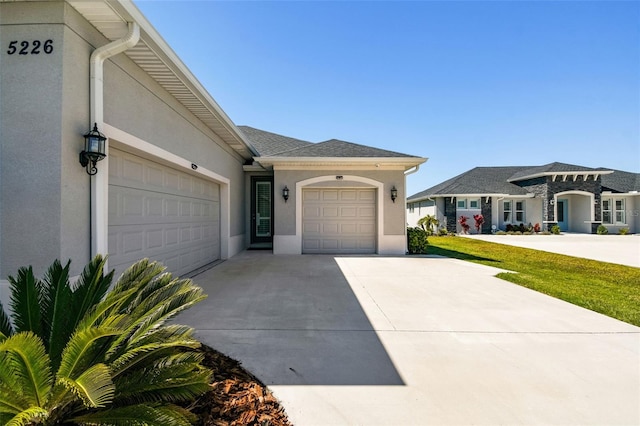 5226 Lake Venice Dr, Wimauma, FL 33598 - view of front of property with stucco siding, concrete driveway, and a garage
