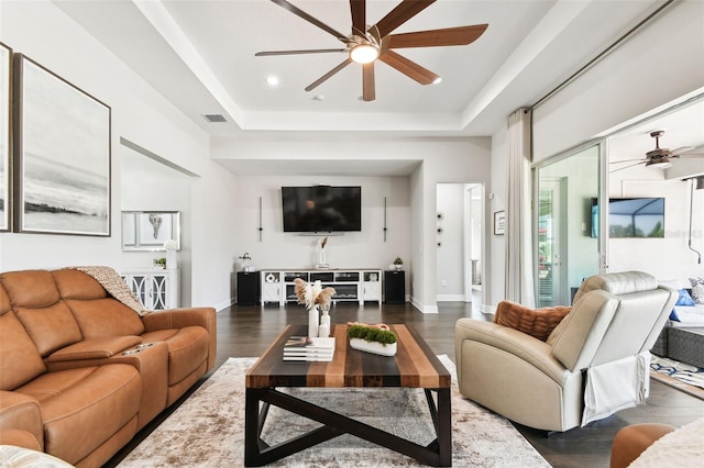 5226 Lake Venice Dr, Wimauma, FL 33598 - living area with a ceiling fan, wood finished floors, visible vents, baseboards, and a raised ceiling