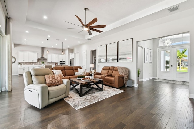 5226 Lake Venice Dr, Wimauma, FL 33598 - living area with visible vents, baseboards, a tray ceiling, and dark wood-style flooring