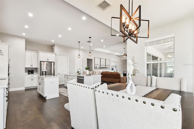 5226 Lake Venice Dr, Wimauma, FL 33598 - living room with recessed lighting, visible vents, dark wood-style flooring, and ceiling fan with notable chandelier