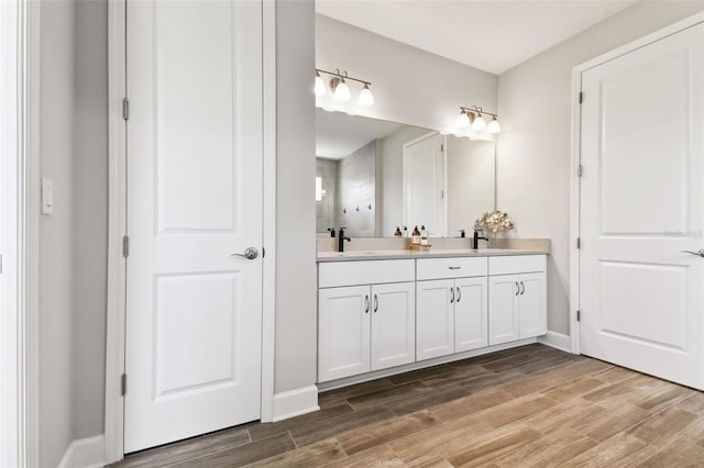 5226 Lake Venice Dr, Wimauma, FL 33598 - full bath with a sink, double vanity, a tile shower, and wood finish floors