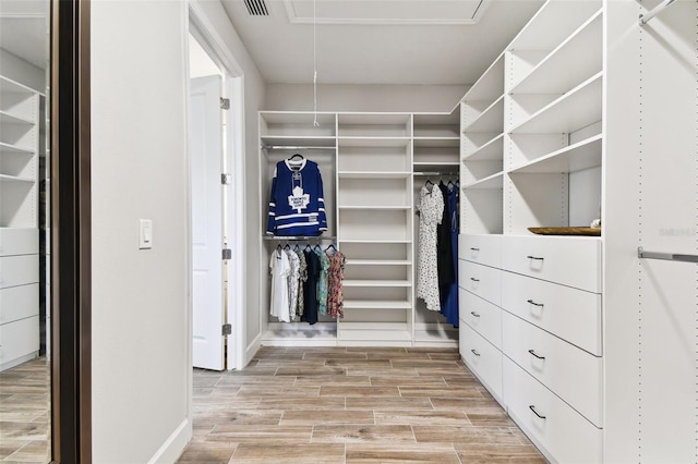 5226 Lake Venice Dr, Wimauma, FL 33598 - walk in closet featuring visible vents, attic access, and wood tiled floor