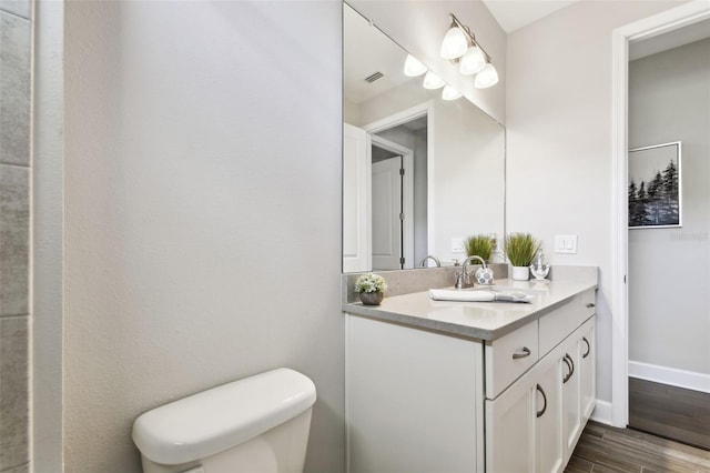 5226 Lake Venice Dr, Wimauma, FL 33598 - bathroom with visible vents, baseboards, toilet, wood finished floors, and vanity