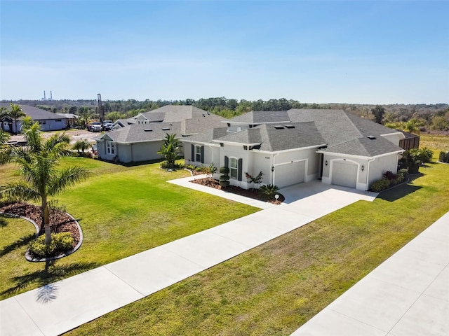 5226 Lake Venice Dr, Wimauma, FL 33598 - view of front of home with a front yard, roof with shingles, an attached garage, stucco siding, and concrete driveway