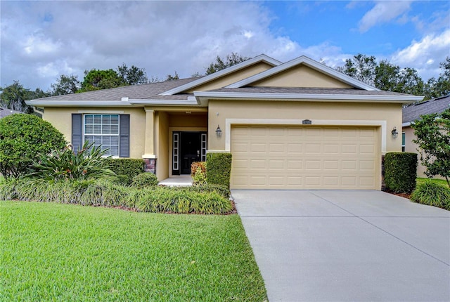 view of front facade with a front lawn and a garage