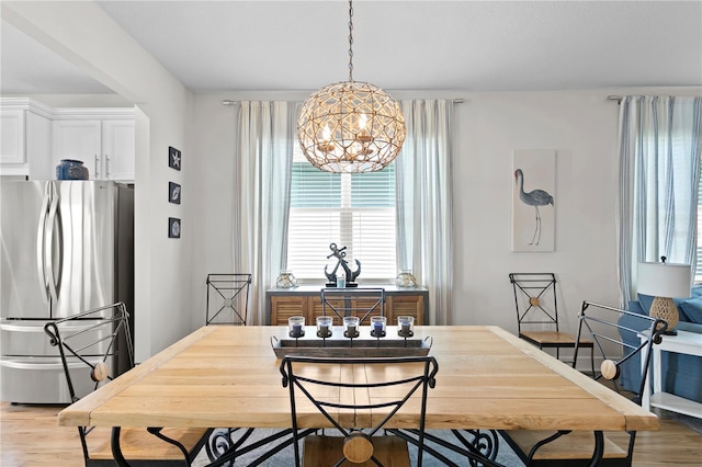 dining room featuring hardwood / wood-style flooring and an inviting chandelier