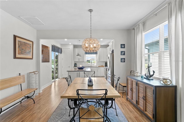 dining area with plenty of natural light and light wood-type flooring