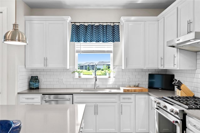 kitchen featuring hanging light fixtures, sink, decorative backsplash, appliances with stainless steel finishes, and white cabinetry