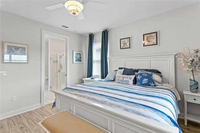 bedroom featuring ceiling fan, ensuite bathroom, and hardwood / wood-style flooring