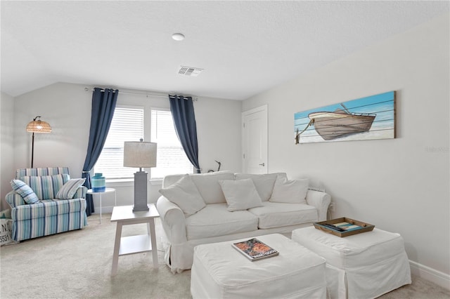 living room featuring a textured ceiling, light carpet, and lofted ceiling