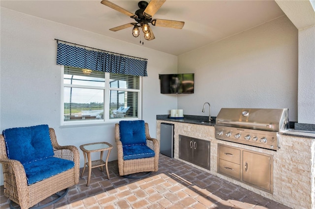 view of patio with a grill, sink, and area for grilling