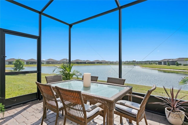 sunroom / solarium with a water view