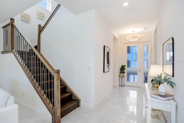 tiled foyer featuring a wealth of natural light