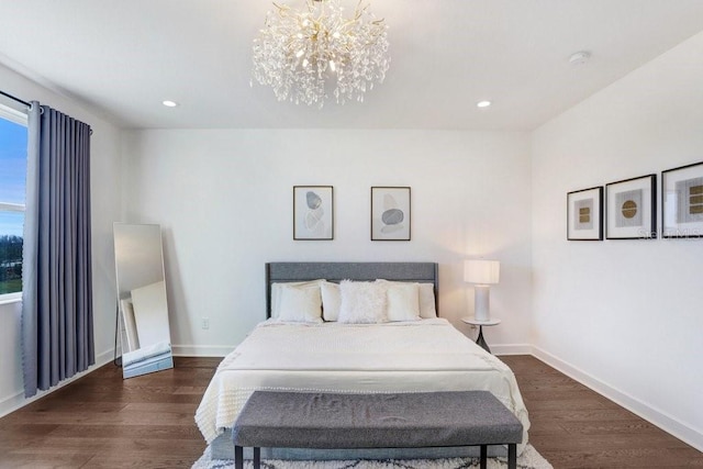 bedroom with dark hardwood / wood-style flooring and a notable chandelier