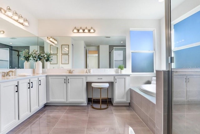 bathroom featuring vanity, tile patterned flooring, and plus walk in shower