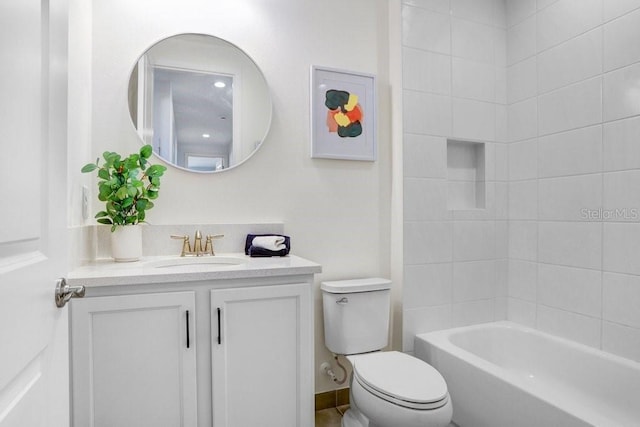 full bathroom with tiled shower / bath, vanity, and toilet