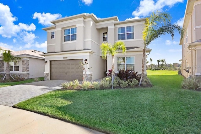 view of front of house with a front yard and a garage