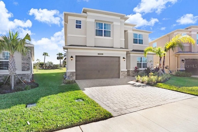 view of front of house with a garage and a front lawn