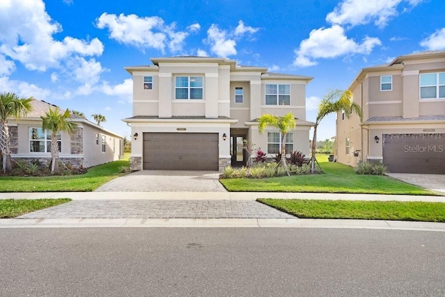 view of front of property with a garage and a front lawn