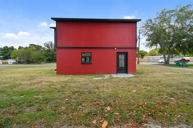 view of home's exterior with a lawn