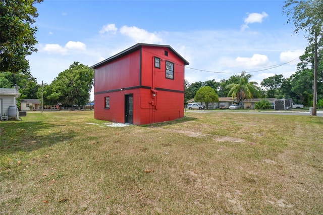 view of outdoor structure featuring a lawn