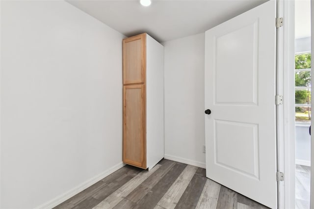 unfurnished bedroom with dark wood-type flooring