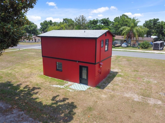 view of outbuilding with a lawn