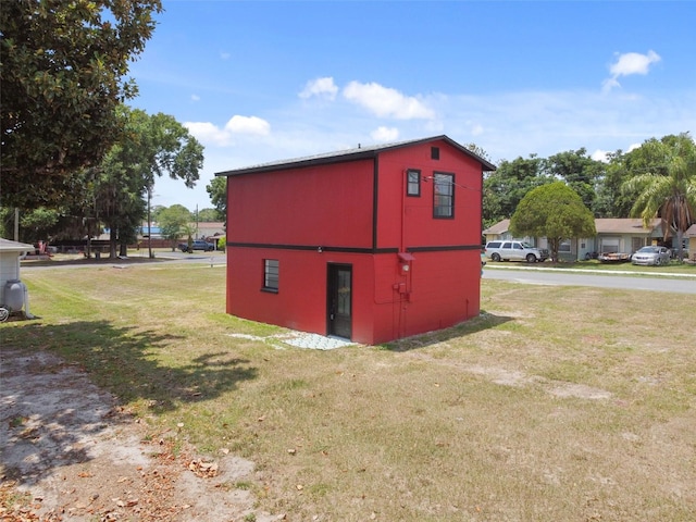 view of outdoor structure featuring a lawn