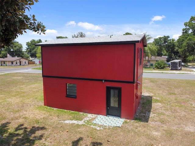 view of outbuilding featuring a lawn