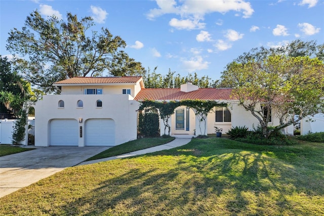 mediterranean / spanish-style home with a front lawn and a garage