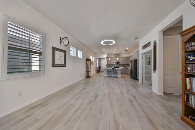 unfurnished living room featuring light hardwood / wood-style flooring and a wealth of natural light