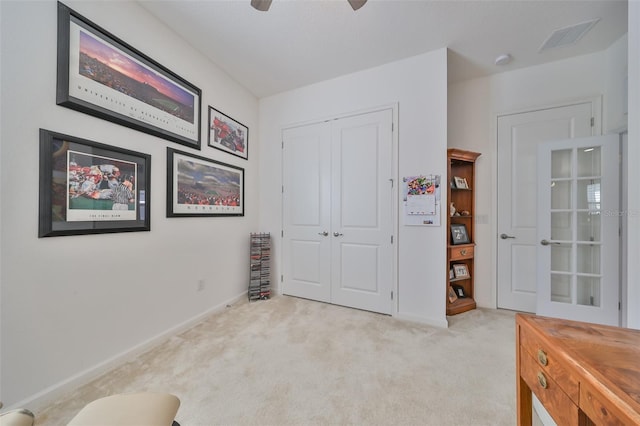 bedroom with ceiling fan, a closet, and light carpet