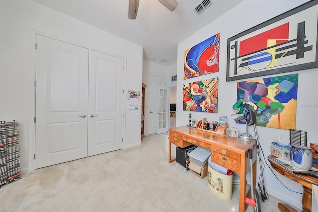 carpeted office featuring ceiling fan